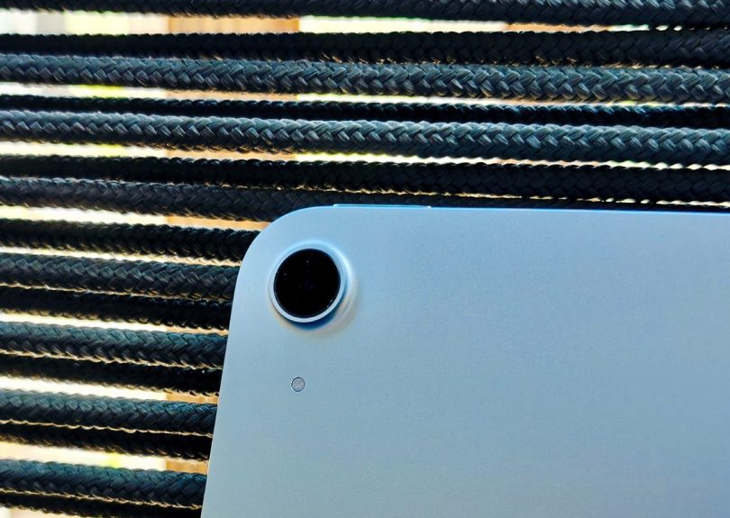 Gros plan sur le module caméra arrière circulaire et la finition en aluminium brossé d'une tablette Huawei MatePad Pro 13.2 posée sur un support tressé noir.