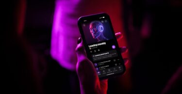 Main tenant un smartphone affichant l'application Deezer en français sur un album marqué Contenu généré par IA, dans une ambiance rouge et violette