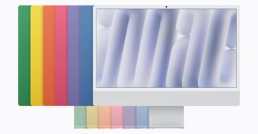 Le nouvel iMac 24 pouces avec puce M6 vu de face, devant les sept coloris de la gamme (vert, jaune, orange, rose, violet, bleu et argent) disposés en éventail