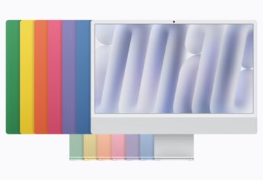 Le nouvel iMac 24 pouces avec puce M6 vu de face, devant les sept coloris de la gamme (vert, jaune, orange, rose, violet, bleu et argent) disposés en éventail