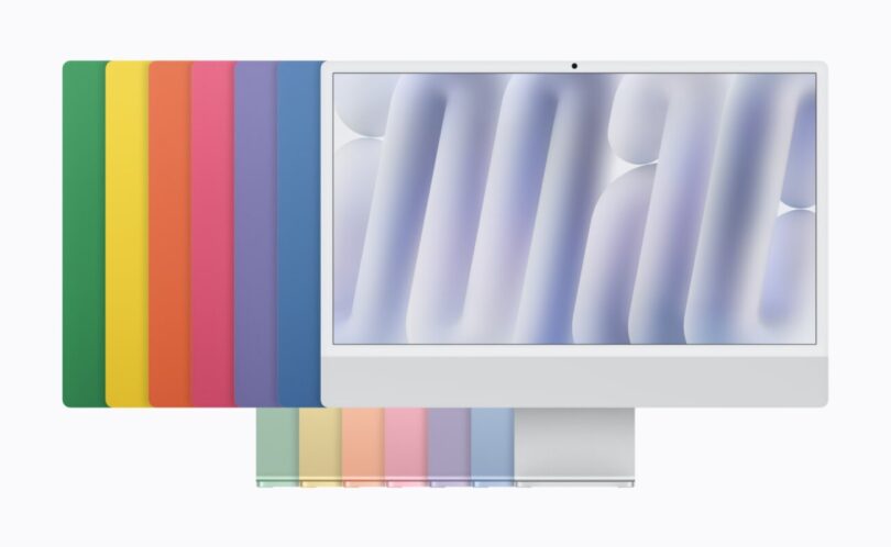 Le nouvel iMac 24 pouces avec puce M6 vu de face, devant les sept coloris de la gamme (vert, jaune, orange, rose, violet, bleu et argent) disposés en éventail