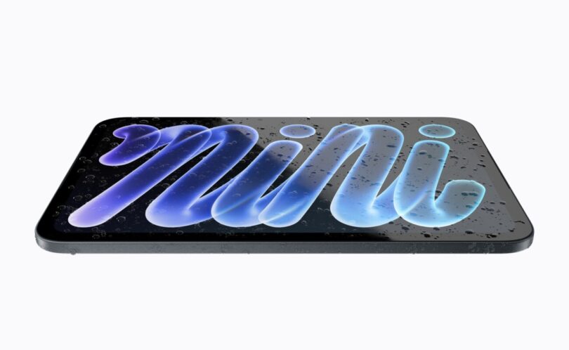 Le nouvel iPad mini 2026 à écran OLED de 8,5 pouces posé à plat et couvert de gouttes d'eau, illustrant sa certification IP67 contre l'eau et la poussière