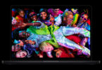 MacBook Pro M5 Pro et M5 Max ouvert sur fond noir, son écran Liquid Retina XDR affichant une photo très colorée, modèle actuel avant l'événement Apple du 28 octobre